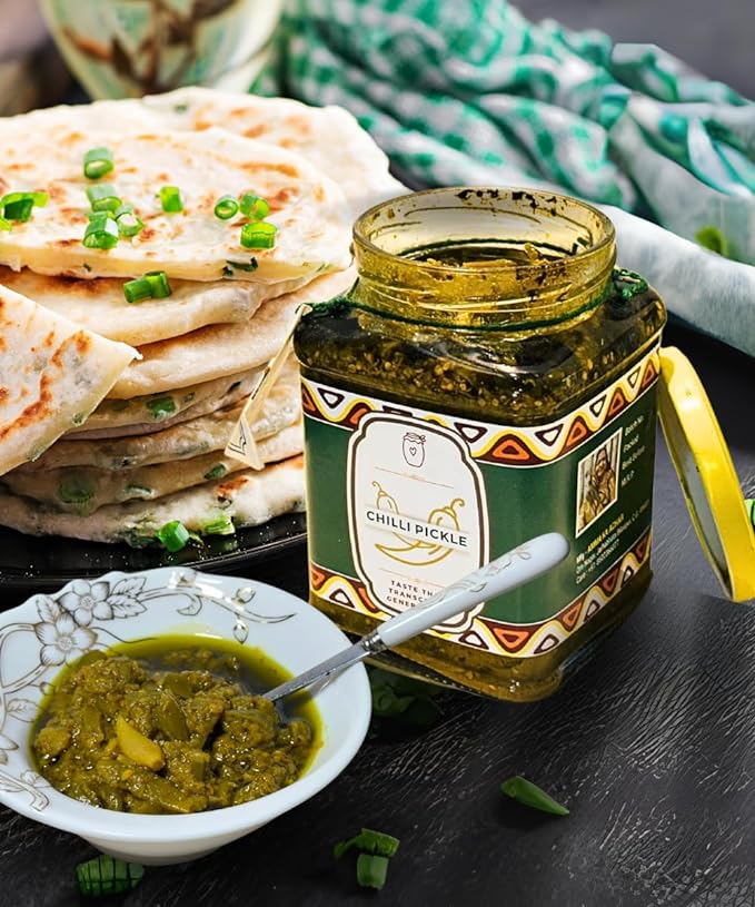 picture of green chilli pickle served with naan and paratha on a bowl | hari mirch ka achar